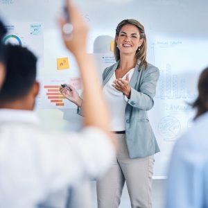 Business coaching, question and woman speaker in business meeting presentation for teamwork, market.